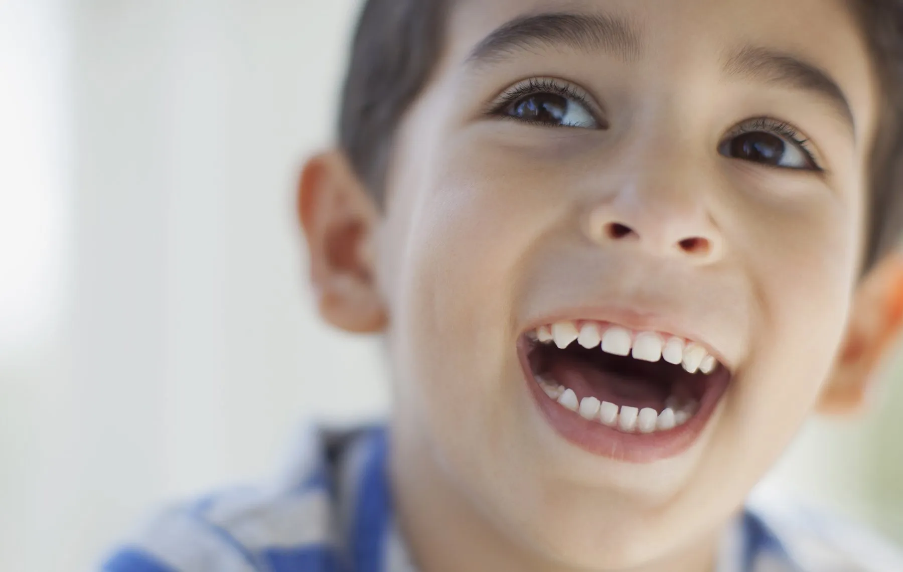 close up of elementary aged boy looking excited