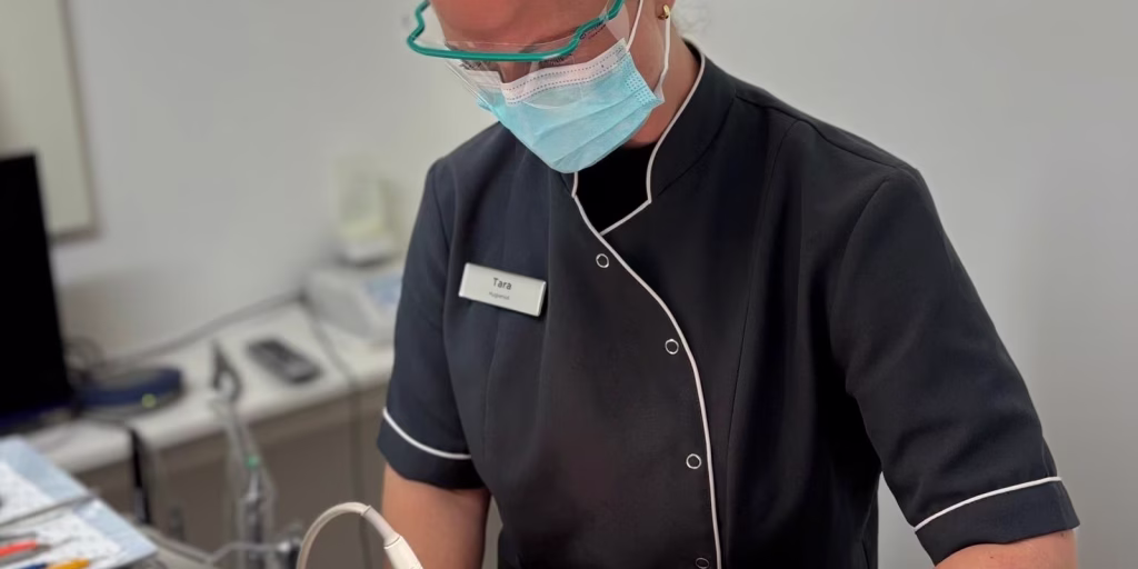 Dentist performing a routine dental checkup on a patient in Aspired Smiles Clinic.